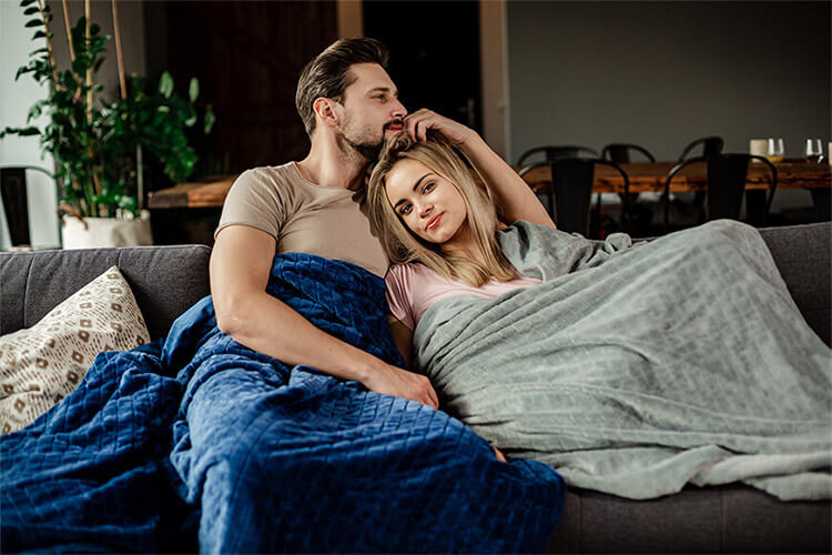 Weighted blanket man hugs woman